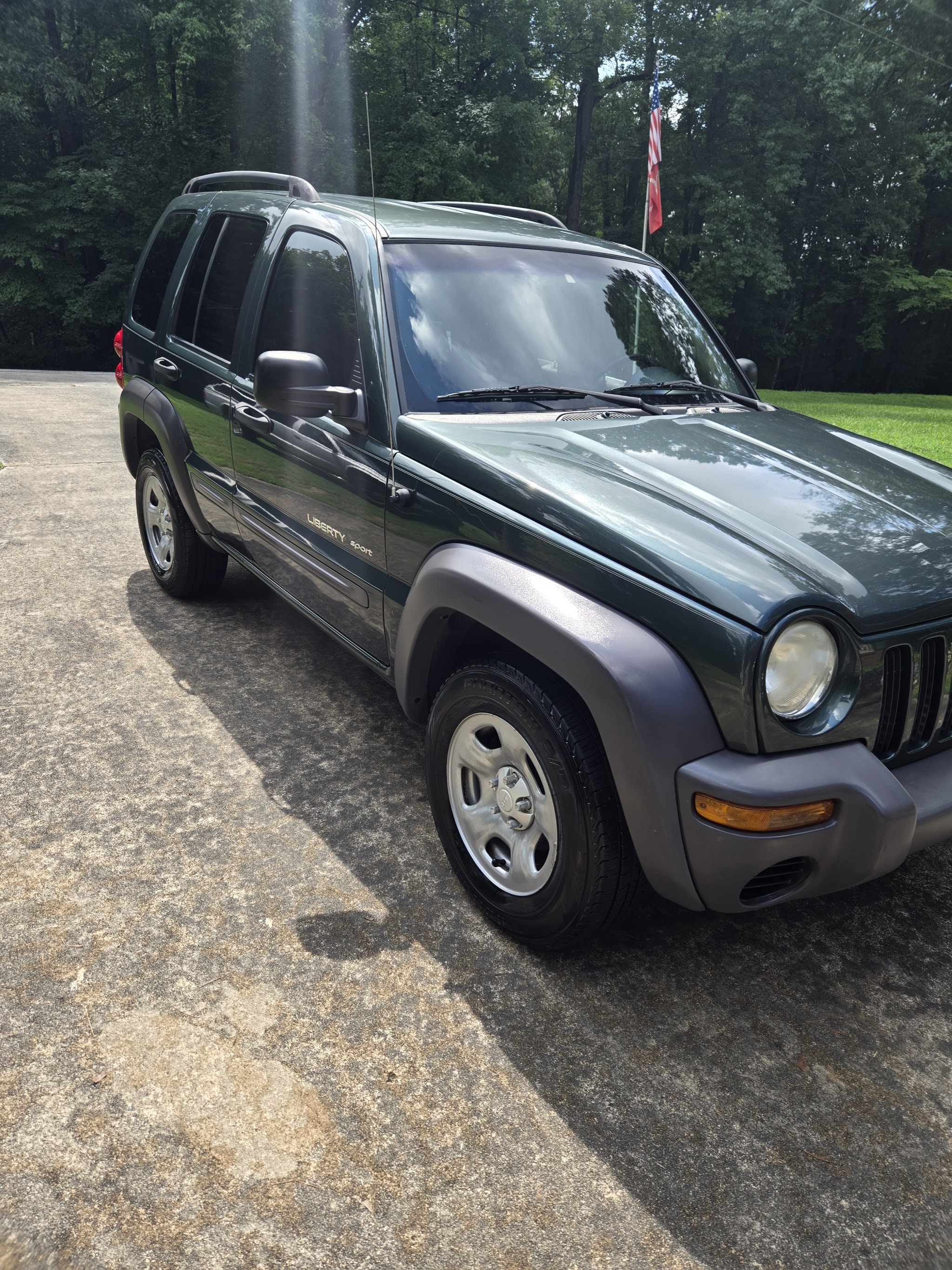 Dark green Jeep Liberty with a clean finish