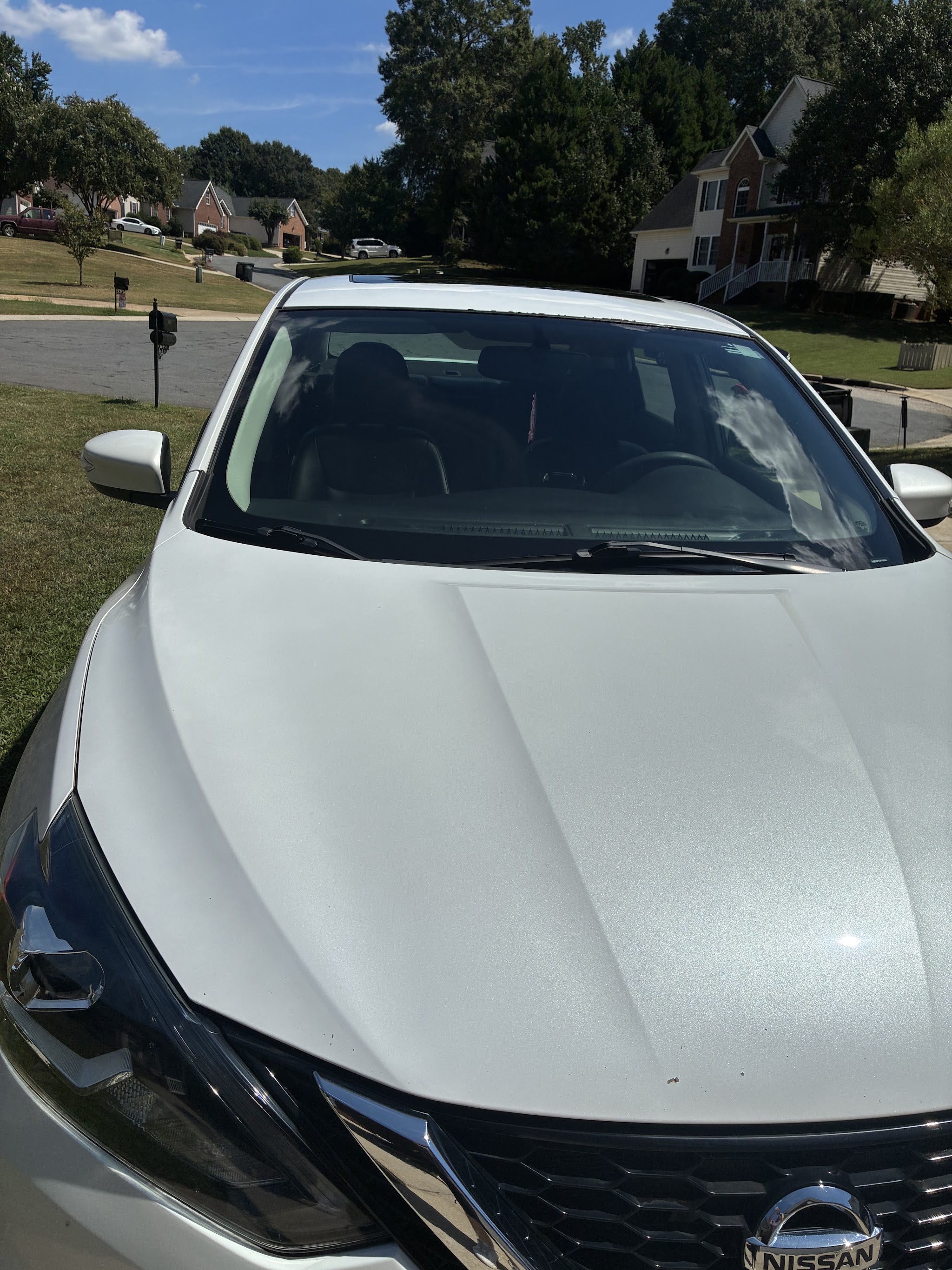 White Nissan front end after a wash